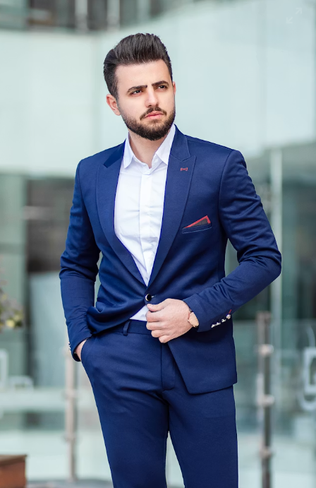 Corporate blazer set manufactured by Divine Uniform, featuring a tailored navy blazer with embroidered company logo, white formal shirt, and matching trousers for office professionals in Delhi